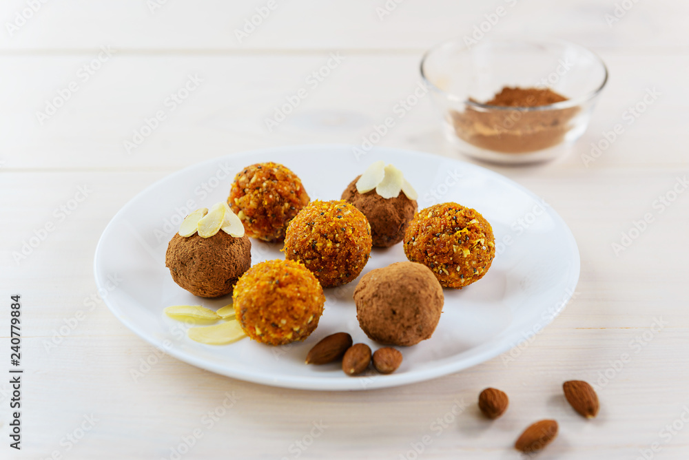 Candy of dried fruits and nuts on a white plate Candy of dried fruits and nuts on a white plate