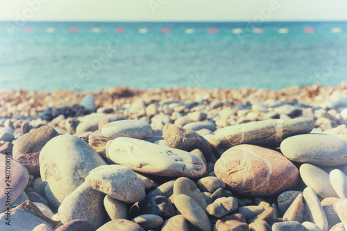 Pebbles on the shore and the sea horizon