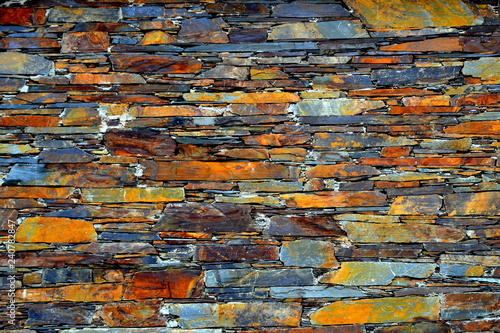 Close-up detail view of an old traditional stone wall built from schist in Piodão, made of shale rocks stack, one of Portugal's schist villages in the Aldeias do Xisto. photo