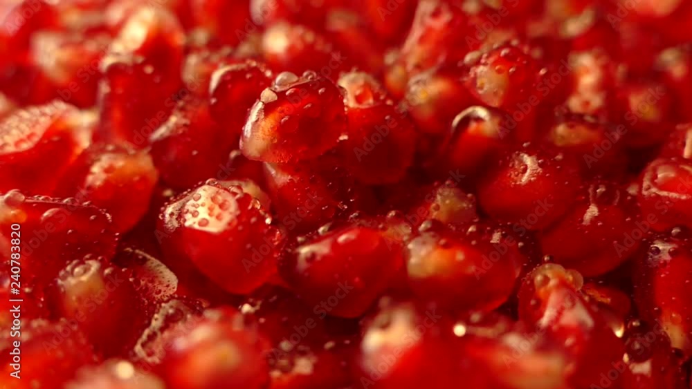 Pomegranate fruit is broken into pieces. Pomegranate seeds lie on a platter. Juicy red fruit on a cutting board. Beautiful pomegranate pulp. Pomegranate fruit is broken into pieces. Pomegranate seeds lie on a platter. Juicy red fruit on a cutting board. Beautiful pomegranate pulp.