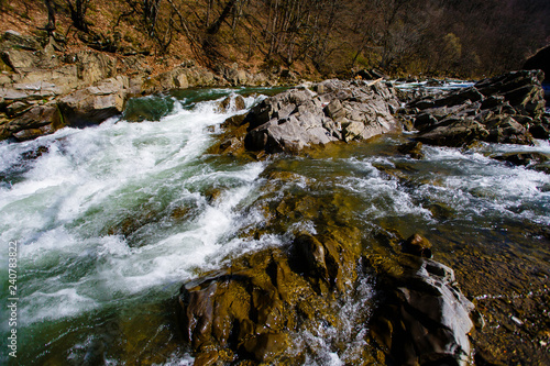 Rocks washed by mountain stream. Spring scenery