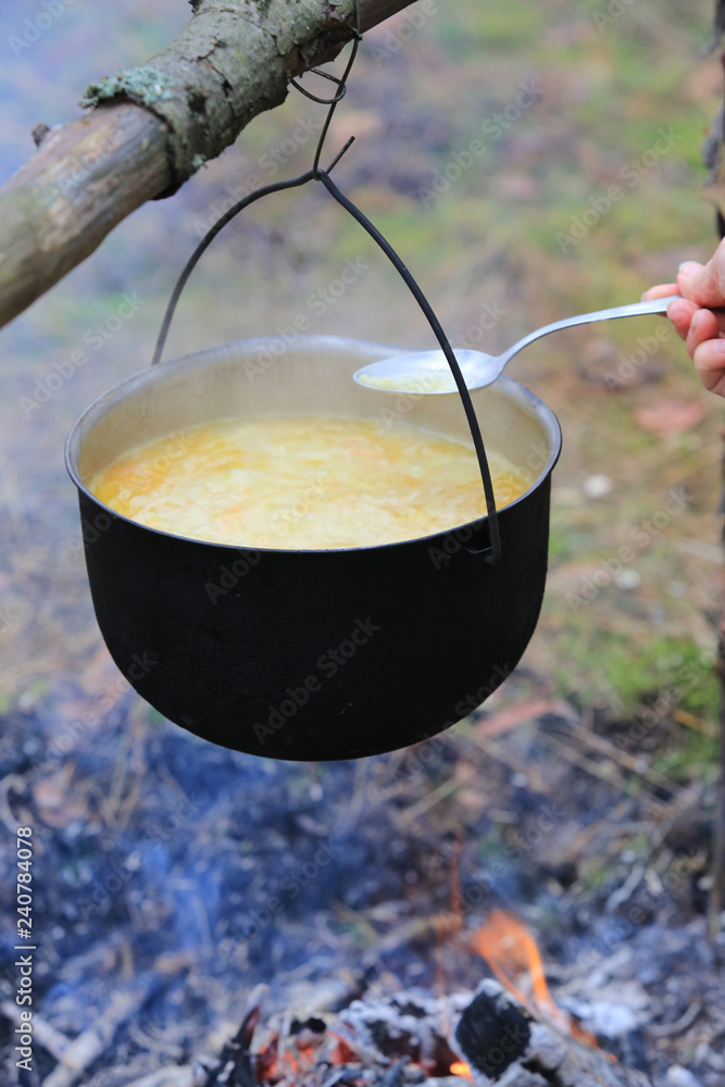 cooking in tourist kettle over campfire cooking in tourist kettle over campfire