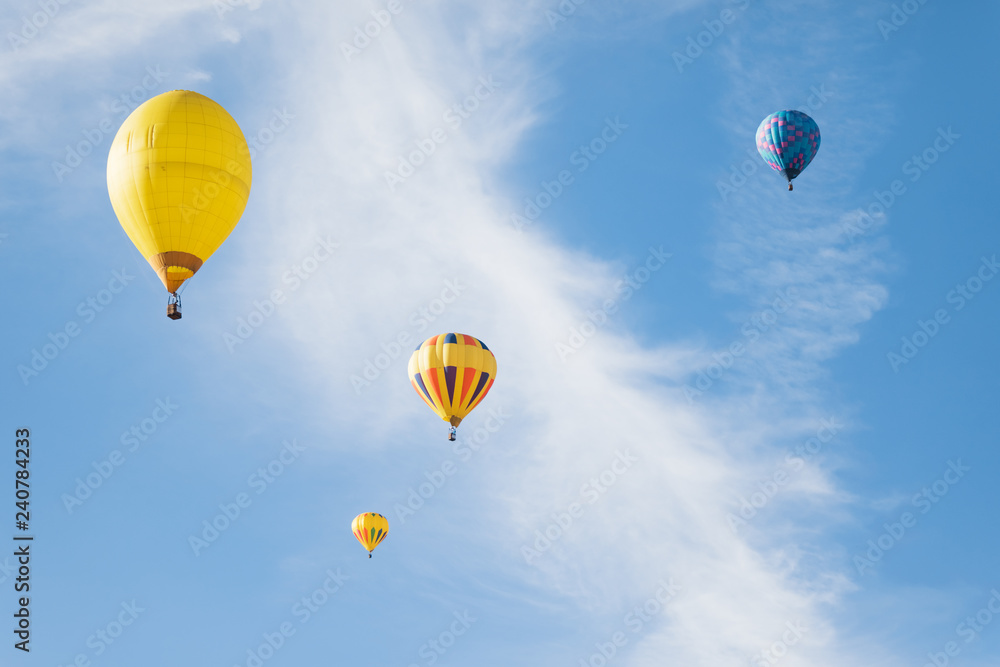 Obraz premium Multi colored hot air balloons flying over blue sky