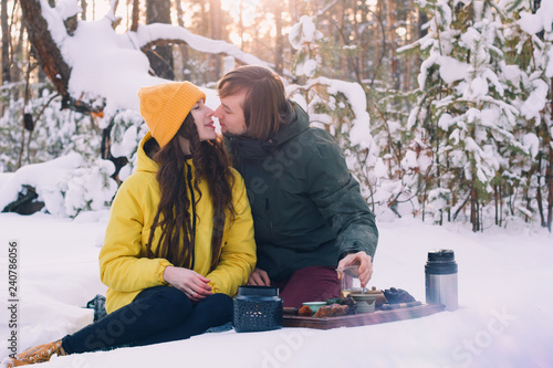 ute couple drinks tea in a winter forest