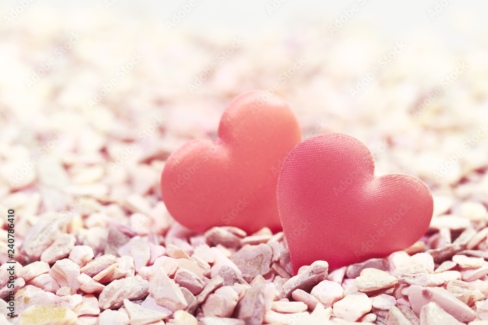Obraz premium Two hearts on pink stones. Concept of love for Valentine's Day