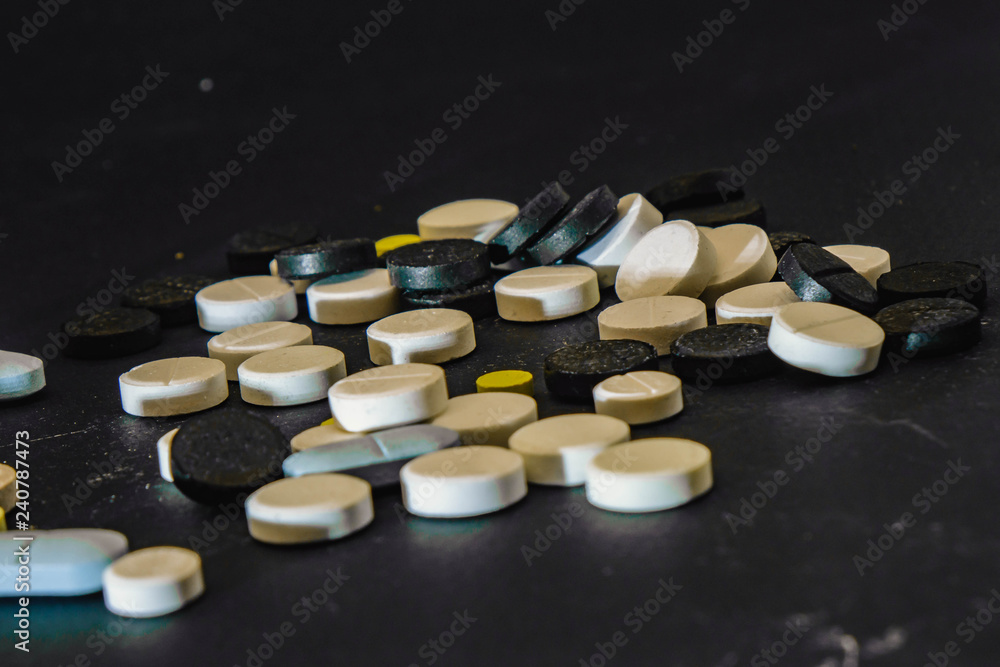 Pile of several medicines on black background Pile of several medicines on black background