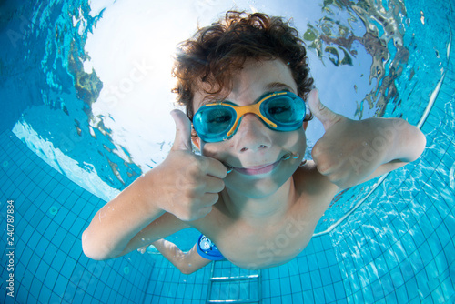 Underwater Young Boy Fun in the Swimming Pool with Goggles