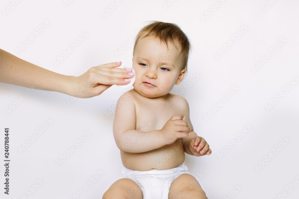 A mother cleaning baby skin, isolated on white background A mother cleaning baby skin, isolated on white background