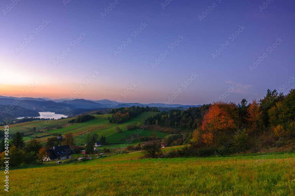 Fototapeta premium Polanczyk, Bieszczady Mountains, Poland: Sun rising over Solina Lake. Views from near hill.