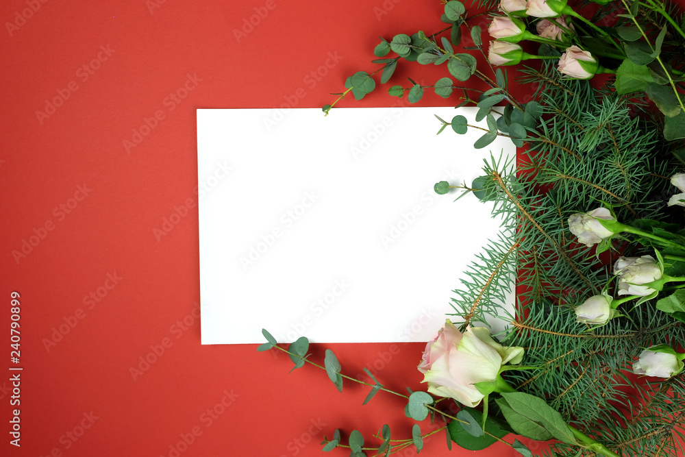 Sheet of paper and a rose on a red background view from the top. Sheet of paper and a rose on a red background view from the top.