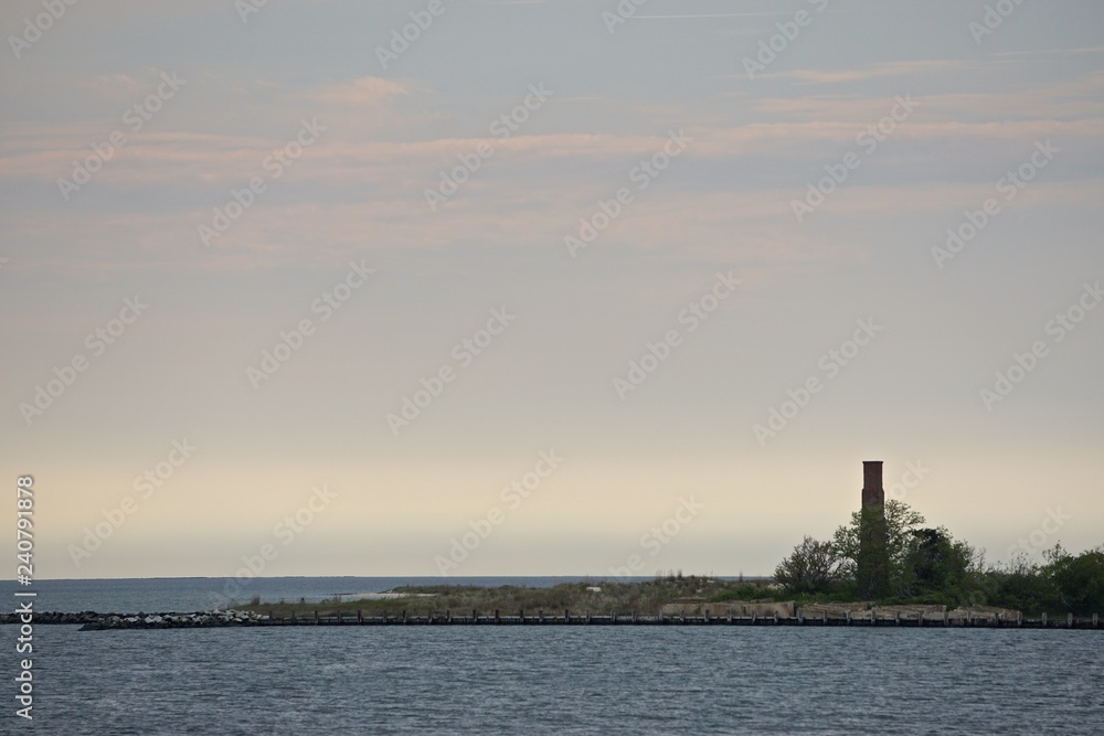 The chimney is all that remains of a factory on an isolated island in the Chesapeake Bay.