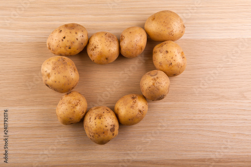 potato heart symbol wooden table nobody 