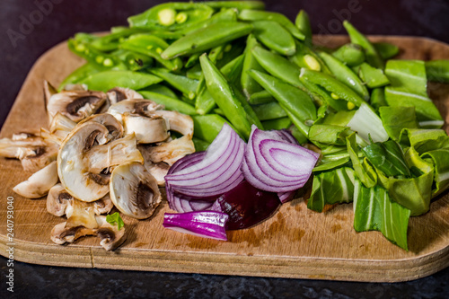 close up of healthy vegetables on a wooden chopping board