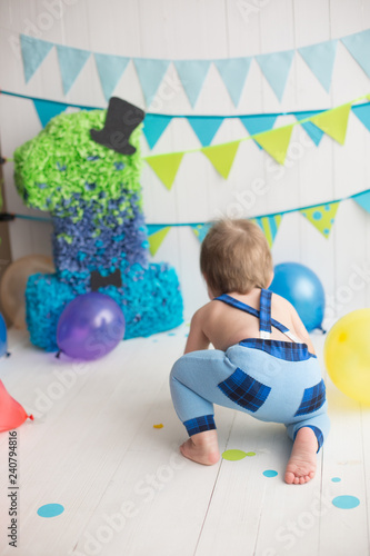 children's holiday. first birthday. a year. balloons. baby's crawling. the child's back