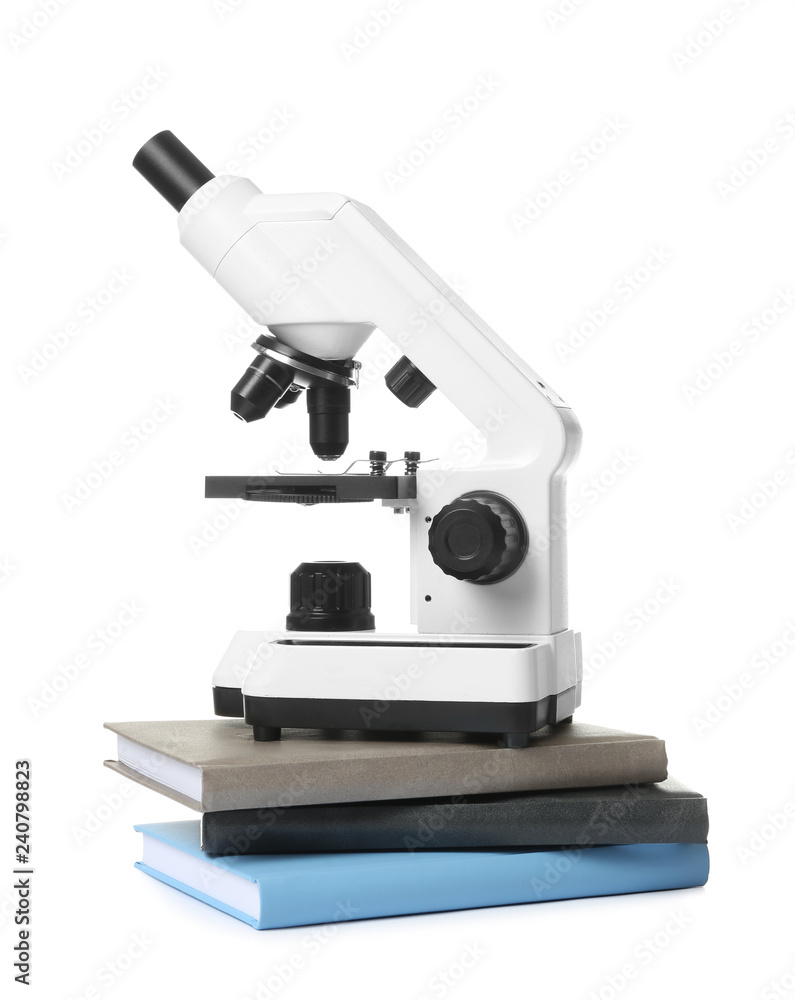 Microscope and books isolated on white. Medical students stuff Microscope and books isolated on white. Medical students stuff