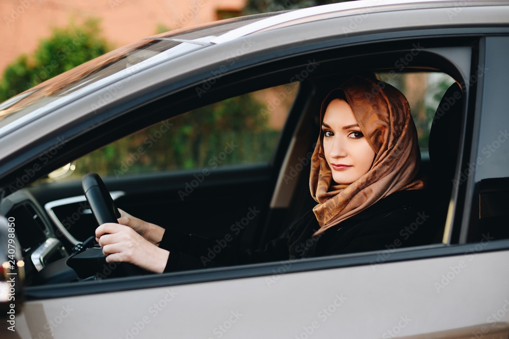 Muslim woman in car as driver