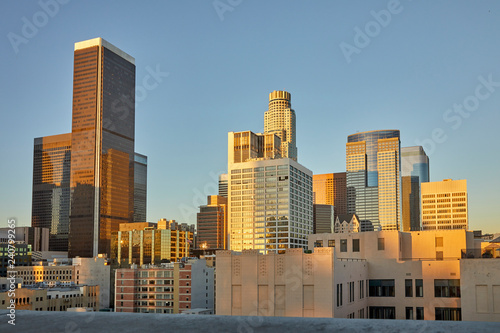 Skyline with sun setting over skyscrapers in downtown Los Angeles  California USA
