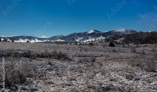 Beautiful winter landscape photo, bright daylight,mountain covered with snow in the background