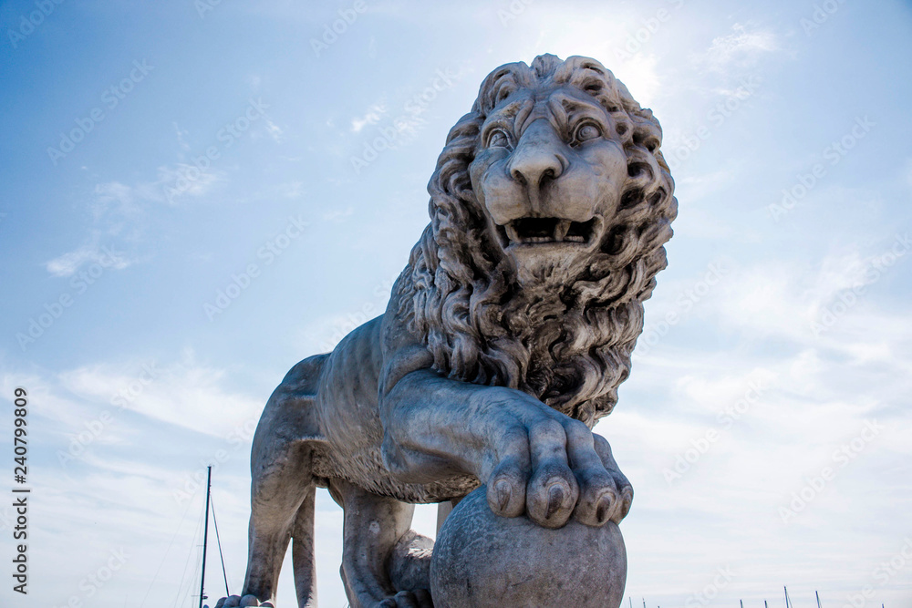 statue of lion on background of blue sky statue of lion on background of blue sky
