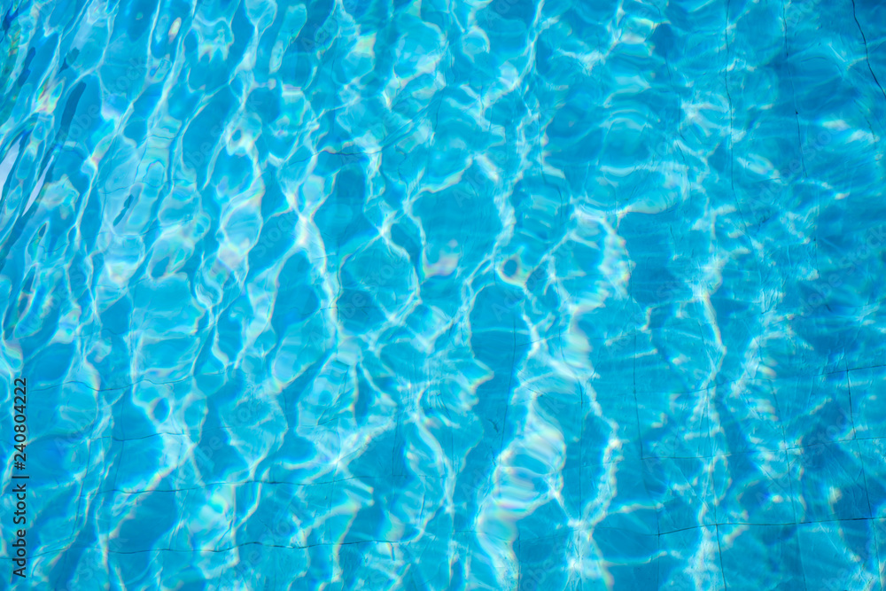 Blue and bright ripple water and surface in swimming pool. Beautiful motion wave in pool