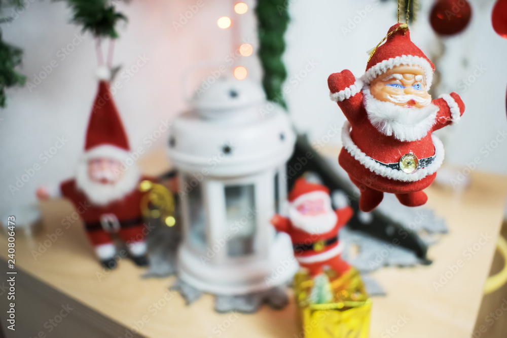 three Santa Claus on Christmas tree with a candle lantern