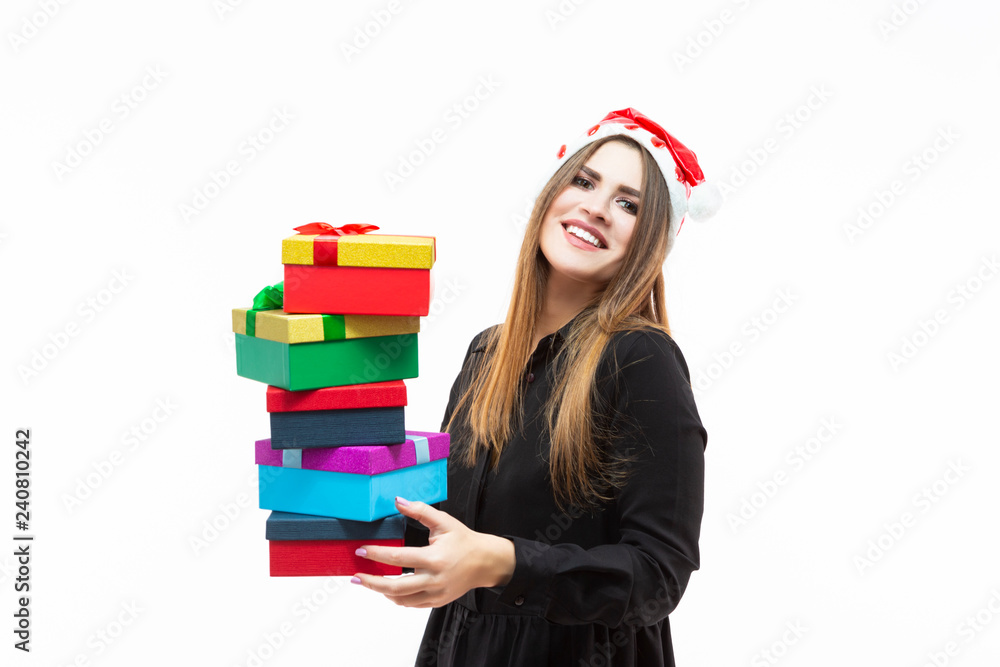 Portrait of Happy Caucasian Brunette Santa Girl Holding Heap of Colorful Gift Boxes Wrapped Up with Ribbons. Against White. Portrait of Happy Caucasian Brunette Santa Girl Holding Heap of Colorful Gift Boxes Wrapped Up with Ribbons. Against White.