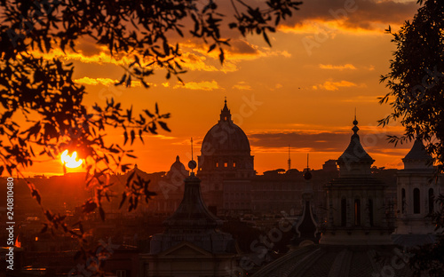 View of Rome historic center skyline with ancient domes and bell towers at sunset