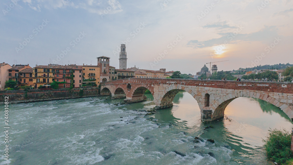 Ponte Pietra over Adige river, with the bell tower of Verona cathedral, in Verona, Italy