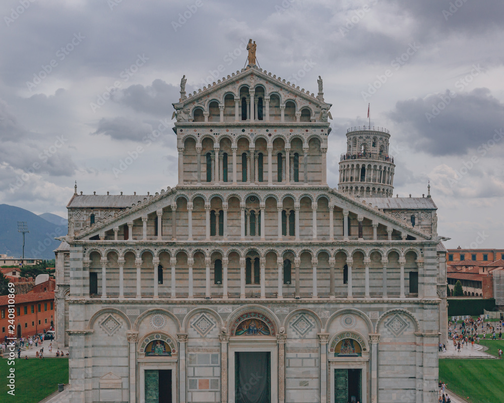 Frontal view of the facade of the Pisa Cathedral with the Leaning Tower of Pisa in the back, in Pisa, Italy