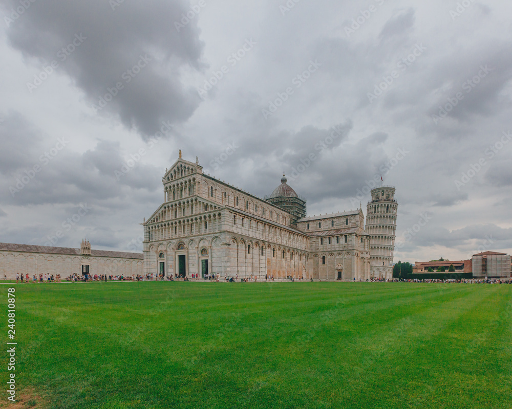 Pisa Cathedral and Leaning Tower of Pisa over the lawn of Cathedral Square in Pisa, Italy