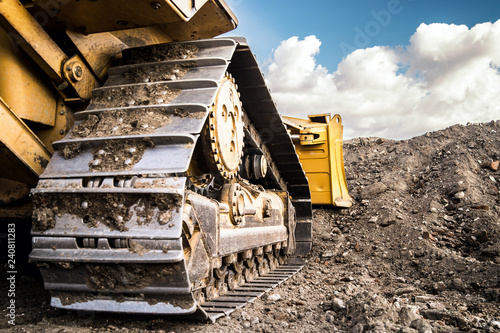 bulldozer at construction site working on soil arrangement 