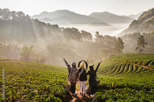 The 3 Asian female Travelers with The beautiful Landscape, strawberry plantation in the morning with the mist, at Ban Nor Lae, Doi Ang Khang, Chaing Mai, Thailand. Explore with best friend