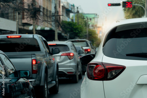White car on the road in traffic junction there are many cars on the road. Stop by red light control in Rayong Thailand. © thongchainak