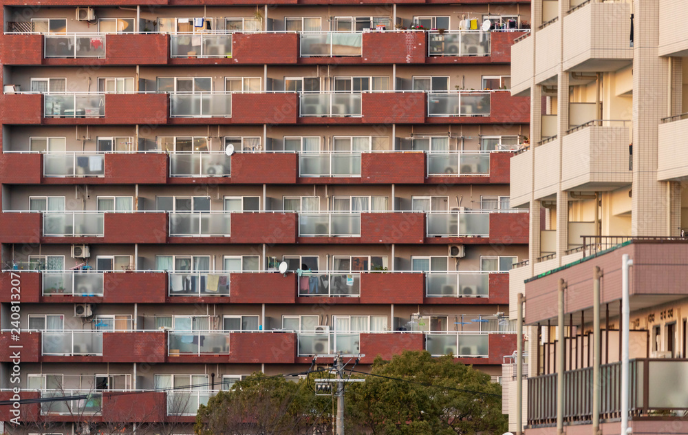 Glass and brick balconies with laundry outside in Japanese apartment block