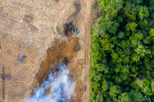 Aerial view of deforestation.  Rainforest being removed to make way for palm oil and rubber plantations photo