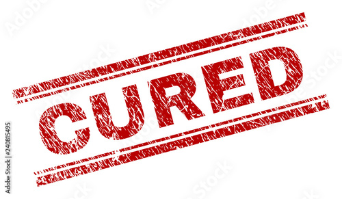 CURED seal print with distress texture. Red vector rubber print of CURED title with scratched texture. Text title is placed between double parallel lines.