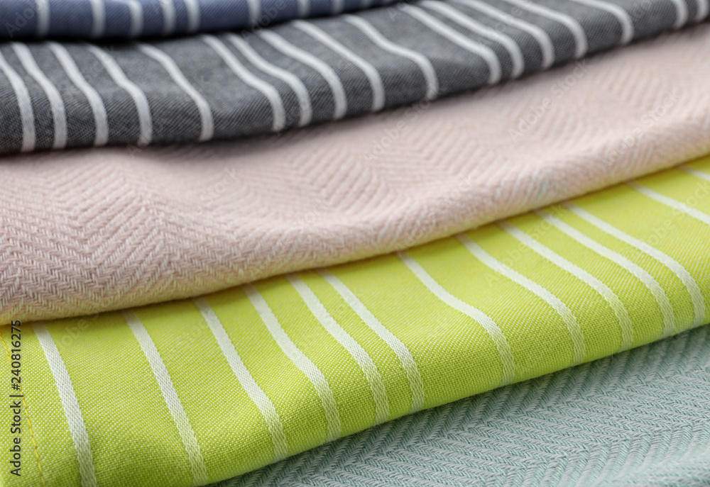 Different folded fabric napkins as background, closeup view Different folded fabric napkins as background, closeup view