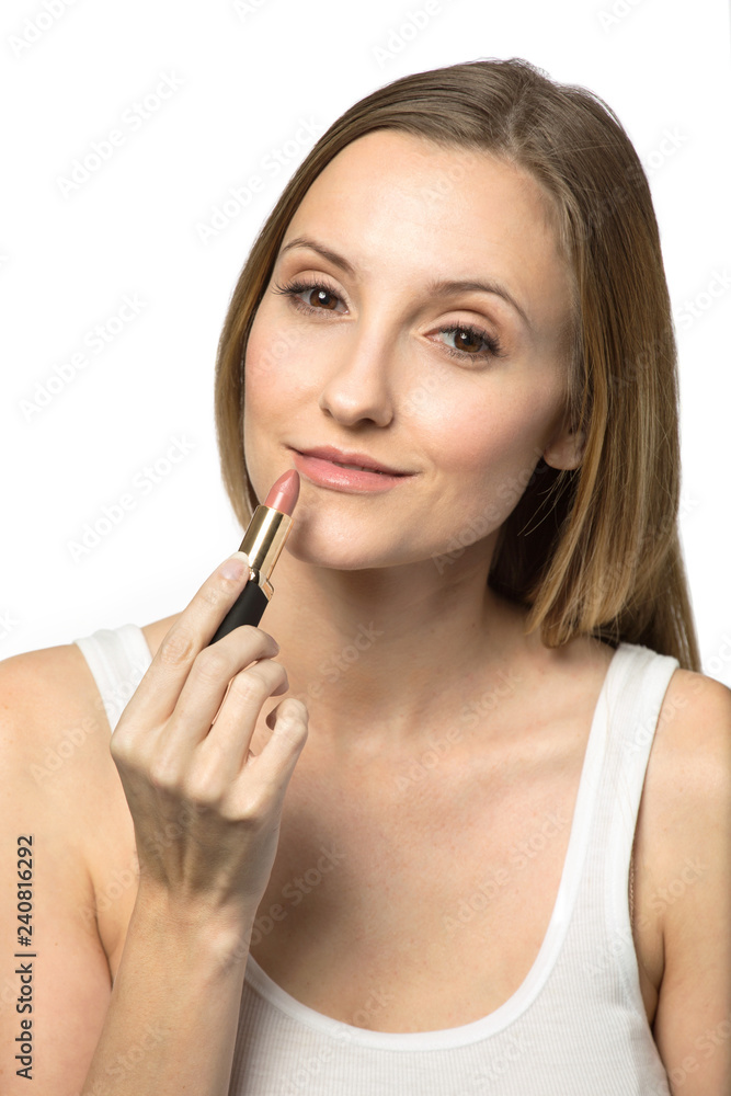 Confident woman applying makeup isolated on white. Confident woman applying makeup isolated on white.