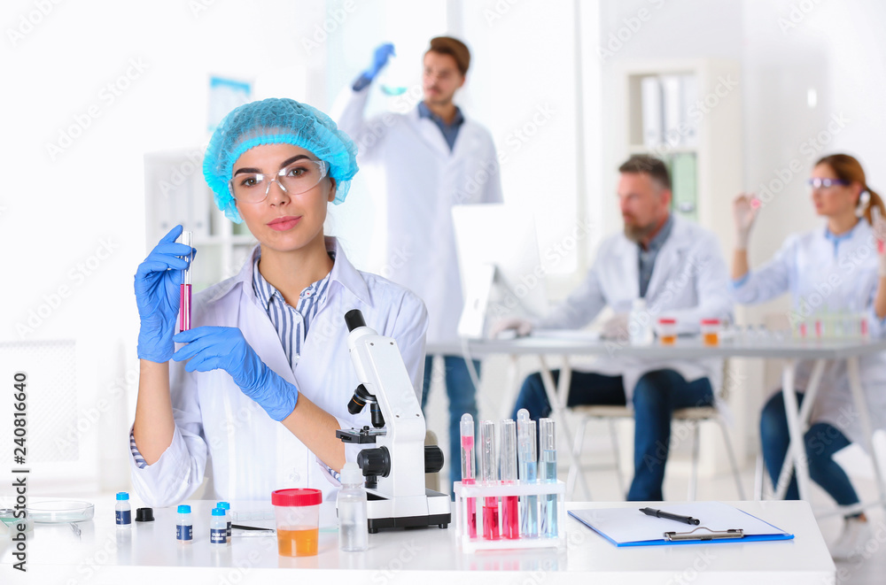 Portrait of female scientist working at table in laboratory, space for text. Research and analysis Portrait of female scientist working at table in laboratory, space for text. Research and analysis