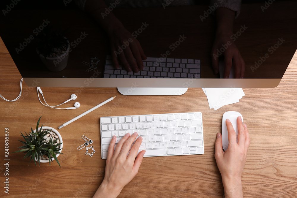 Woman using computer mouse and keyboard at office table, top view Woman using computer mouse and keyboard at office table, top view