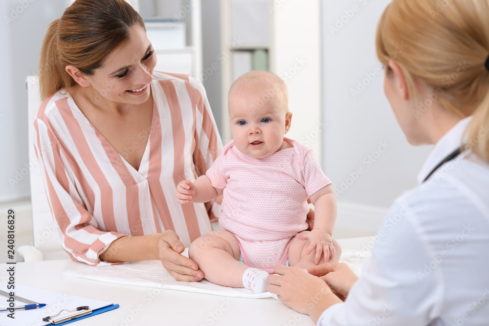 Woman with her baby visiting children's doctor in hospital Woman with her baby visiting children's doctor in hospital