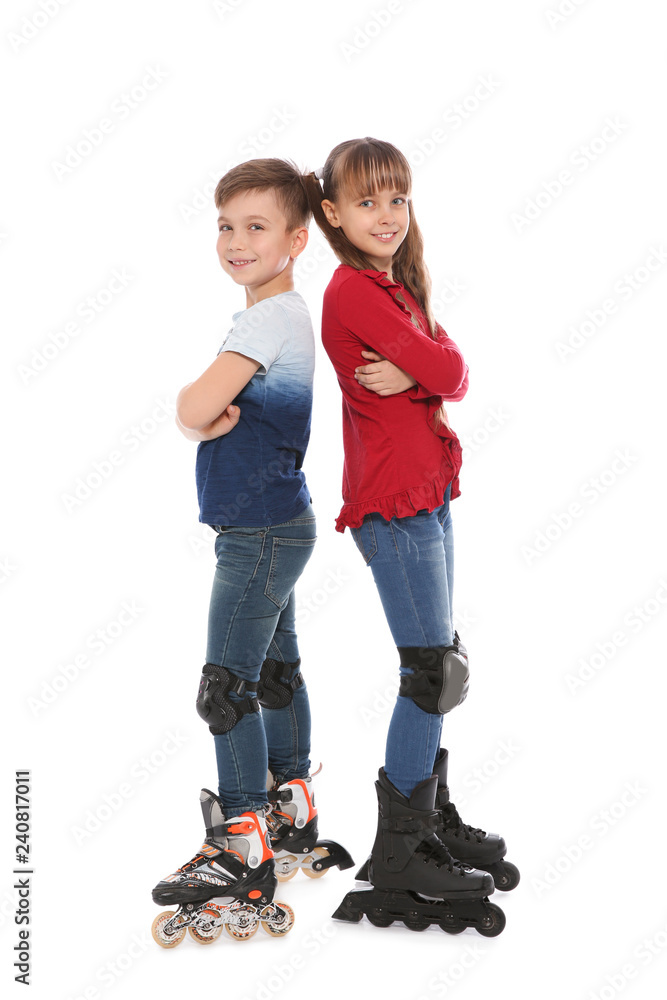 Fototapeta premium Full length portrait of boy and girl with inline roller skates on white background