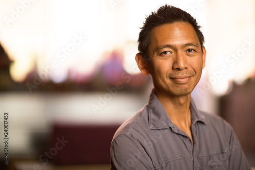 Portrait of a healthy middle age Asian man smiling. photo