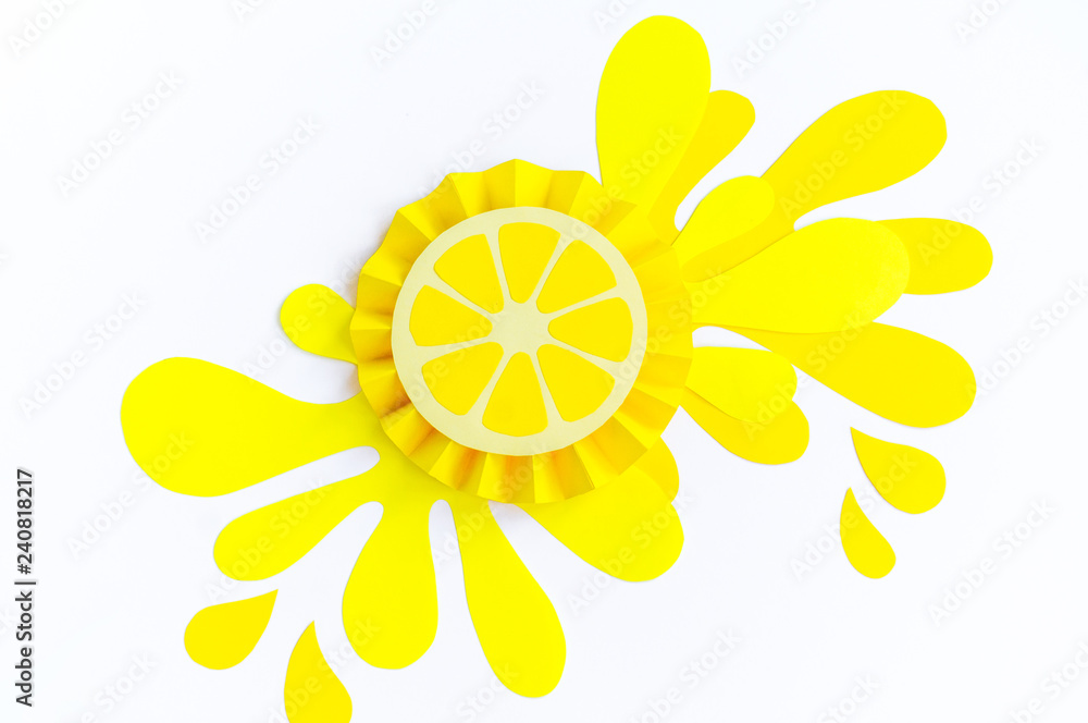 Yellow lemon with splashes made of paper on a white background. Fruit smoothies vegetarian. Yellow lemon with splashes made of paper on a white background. Fruit smoothies vegetarian.