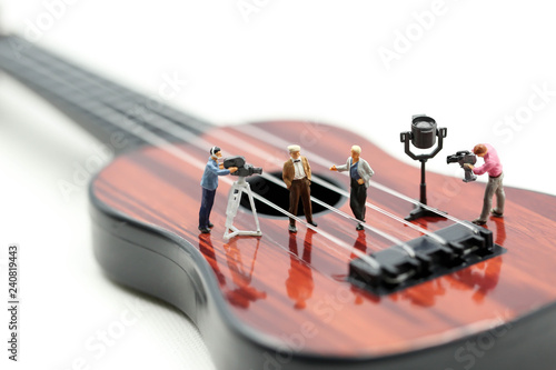 Miniature people : Director, staff and actors on the set of the video singer with guitar,production music concept.