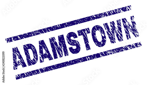 ADAMSTOWN seal print with distress style. Blue vector rubber print of ADAMSTOWN text with corroded texture. Text tag is placed between parallel lines.