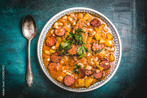 Stew with cabanossi peppers and beans photo