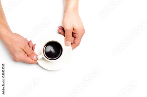 men's hands holding a white cup of coffee on white isolated background, place for text