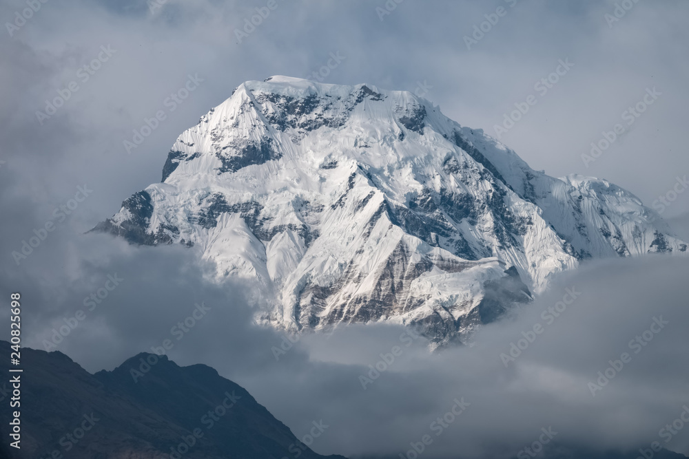 Snow Mountain Peak among Moving Clouds in the Himalayas in Nepal