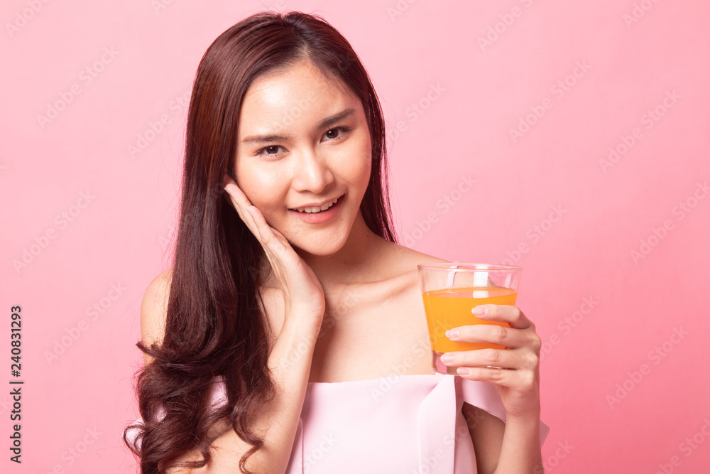 Young Asian woman happy smile with orange juice Young Asian woman happy smile with orange juice